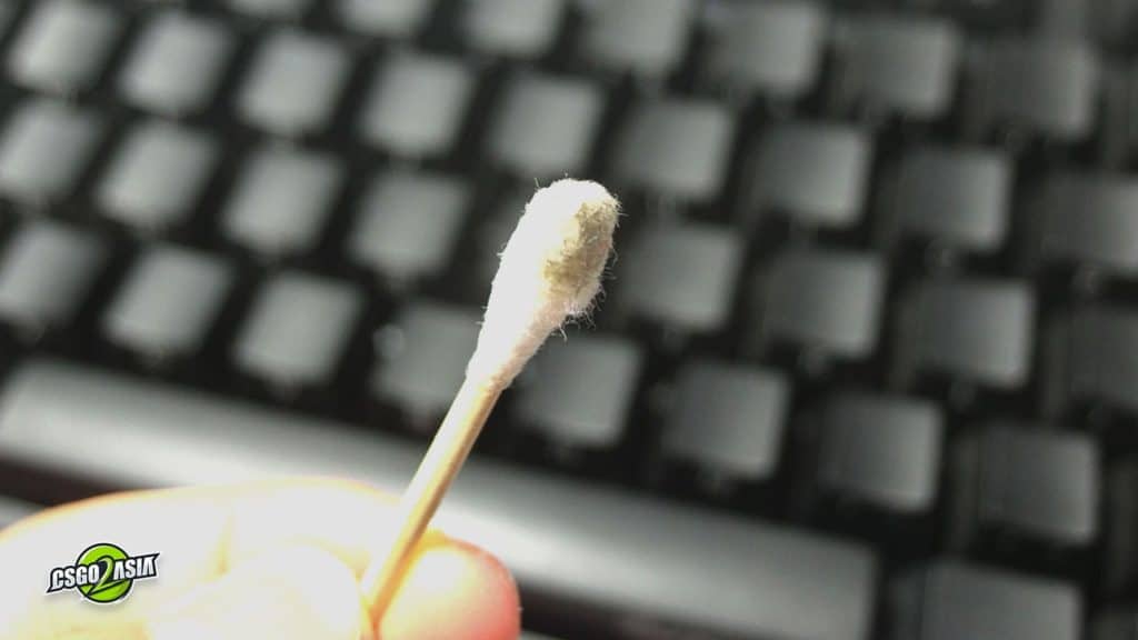 dirty cotton bud after scrubbing between key caps